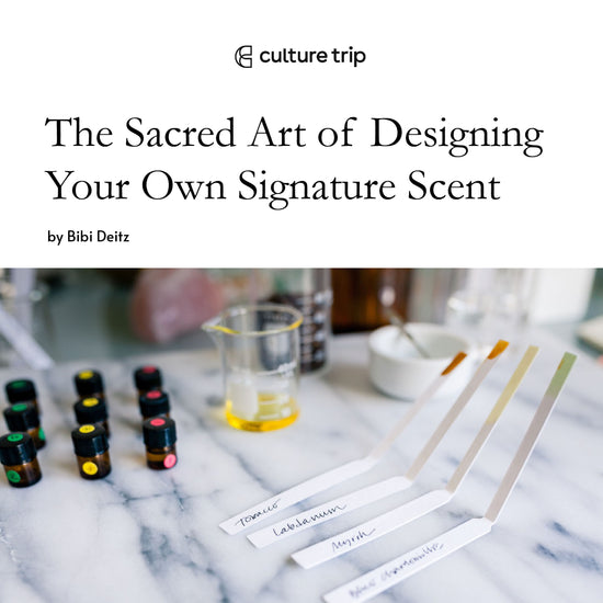 Culture Trip. The Sacred Art of Designing Your Own Signature Scent. A marble table with small brown bottles, a glass beaker with oil and scent testing strips.
