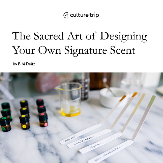  Culture Trip. The Sacred Art of Designing Your Own Signature Scent. A marble table with small brown bottles, a glass beaker with oil and scent testing strips. 